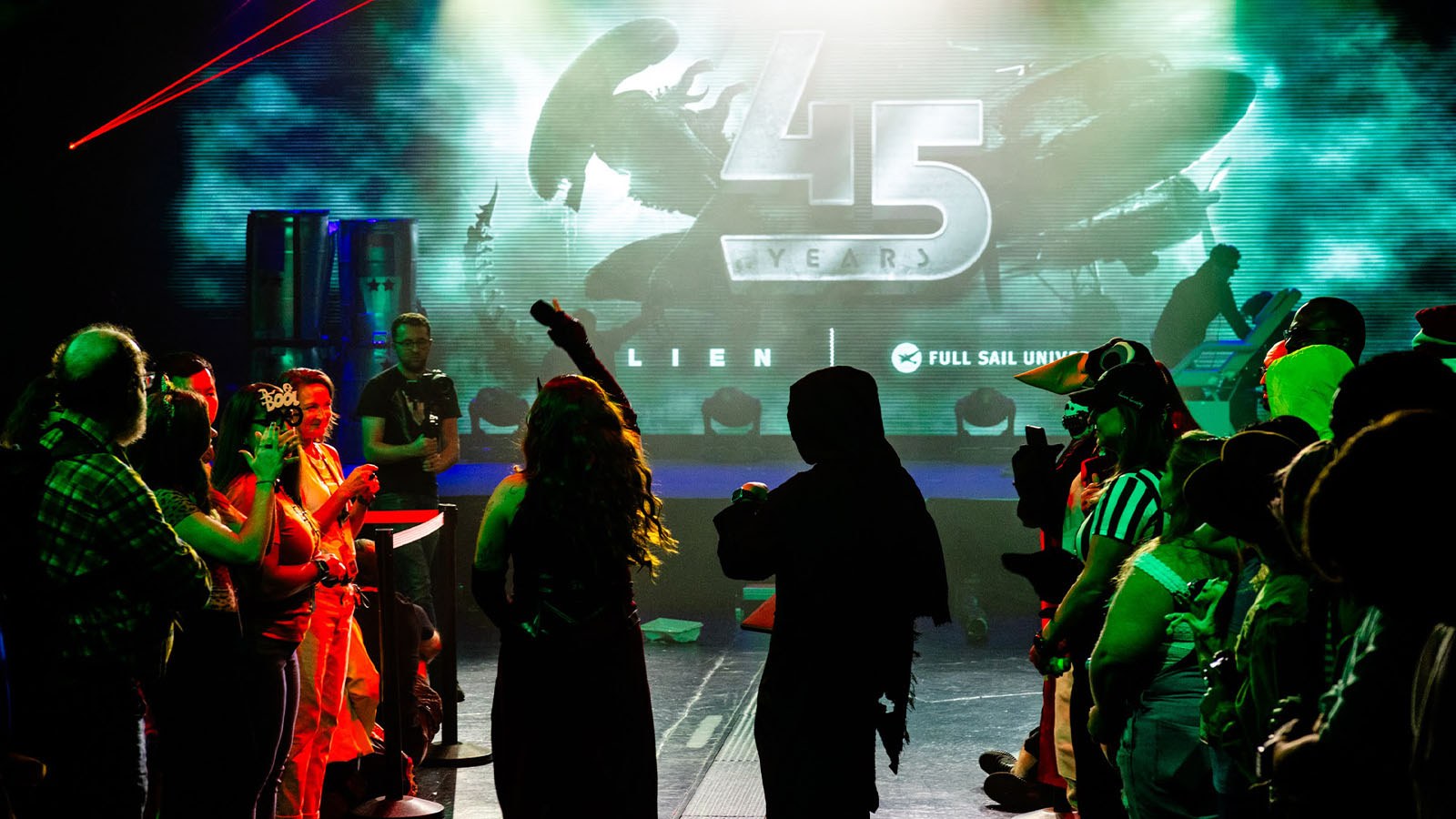 A vibrant crowd in costumes gathers at Full Sail University, celebrating 45 years of the ‘Alien’ franchise for Halloween.