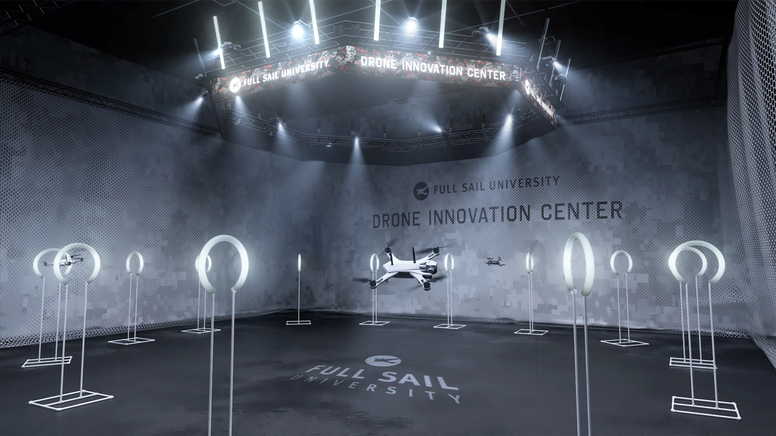 A white drone flies in the netted airspace in Full Sail’s Done Innovation Center. It is surrounded by white rings on stands.