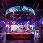 Full Sail’s Fortress dressed for the MCS 25 Kickoff Challenge with dramatic lighting, camera crews, and a small audience watching.