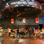 Tables of clothes fill the floor in the Fortress and students stand around looking through the clothing items.