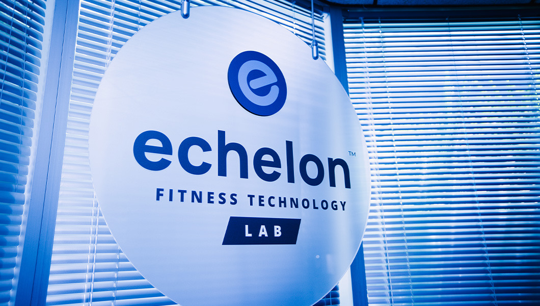 Sign for Full Sail’s Echelon Fitness Technology Lab, featuring blue branding and window blinds in the background.