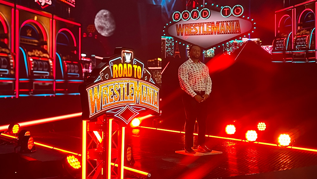 WWE Superstar Big E records content at Studio V1 with ‘Road to WrestleMania’ signage, lights, and a Las Vegas-themed backdrop.