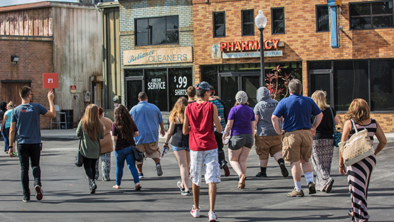 A group explores Full Sail's multi-scened backlot during a tour.